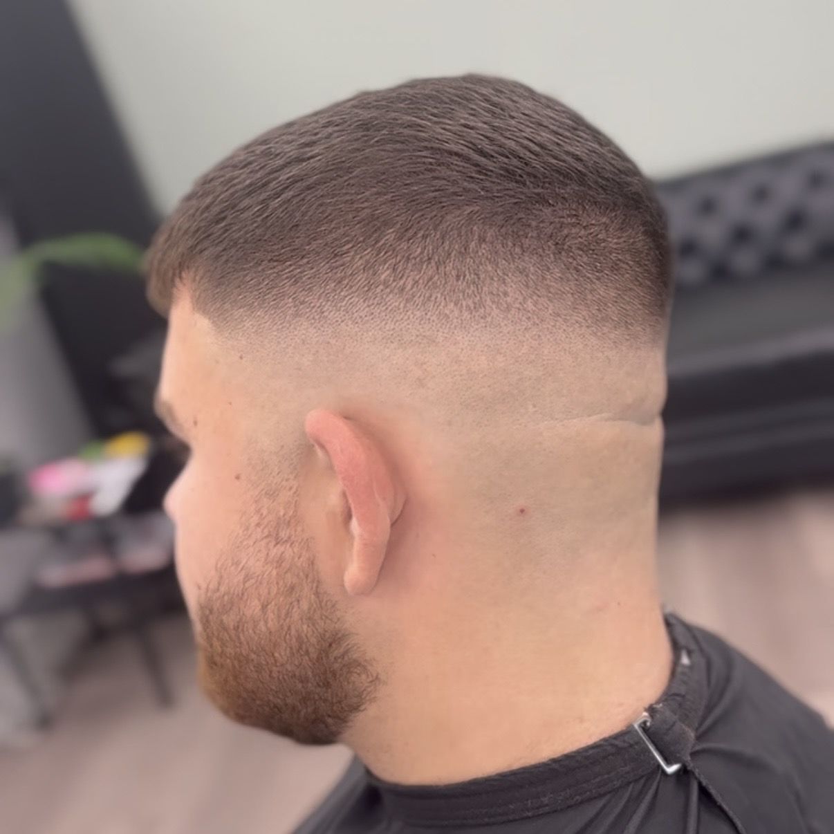 High skin fade blended into a full beard
